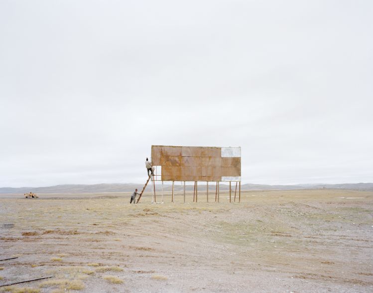 MEN-CLIMBING-A-BILLBOARD-QINGHAI-2011-by-ZHANG-KECHUN-BHC0827MA